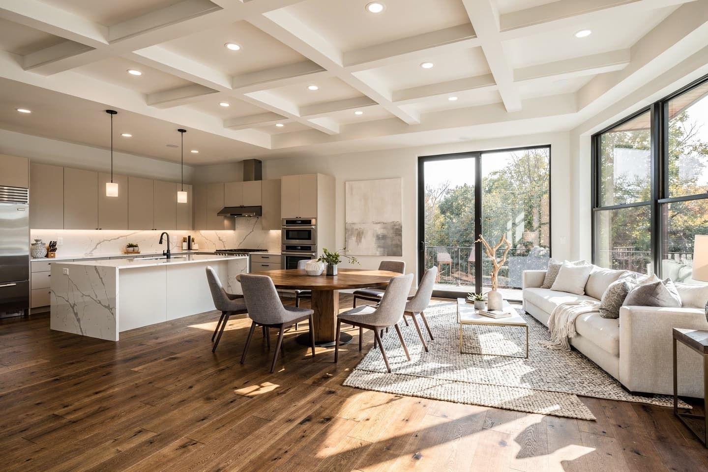 Open living, dining, and kitchen space after a whole-home remodel, with a coffered ceiling and wide windows